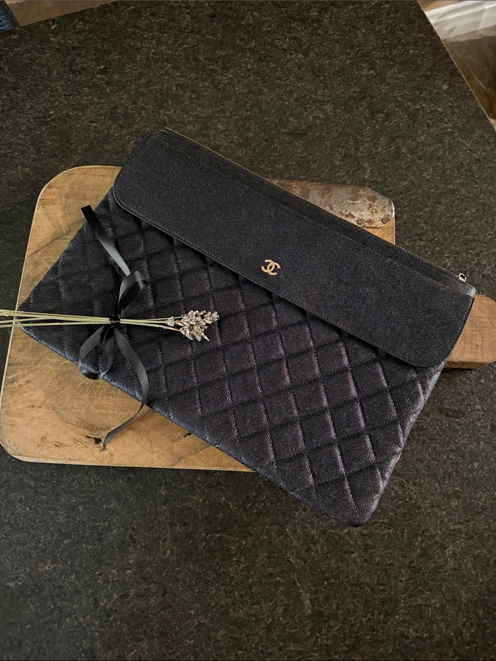 CHANEL Black Quilted O-Case with gold emblem on the front, brand new, never used